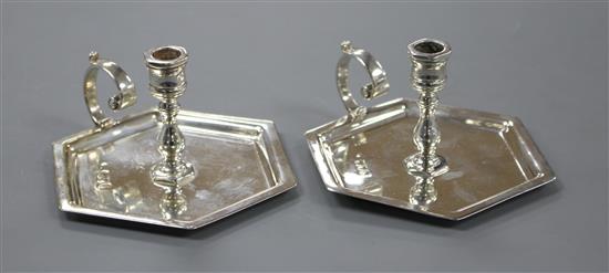 A pair of late Victorian silver hexagonal chambersticks, makers mark rubbed, London, 1897, width 97mm inc. handle, 6.5oz.